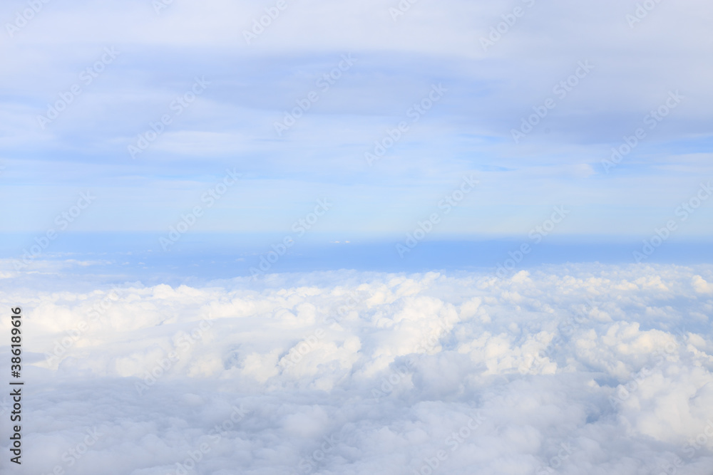 view from airplane window with white cloud and blue sky