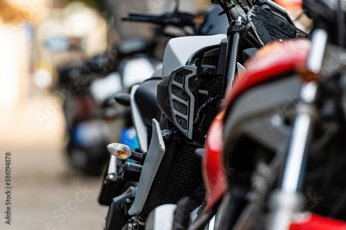 a row of motorcycles parked on the side of the street, close-up of details, selective focus