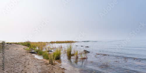 Eastern shore of Lake Baikal on a foggy day. Stones and grass