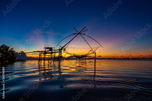Photography Chinese fish nets during sunrise in Phatthalung province, Thailand