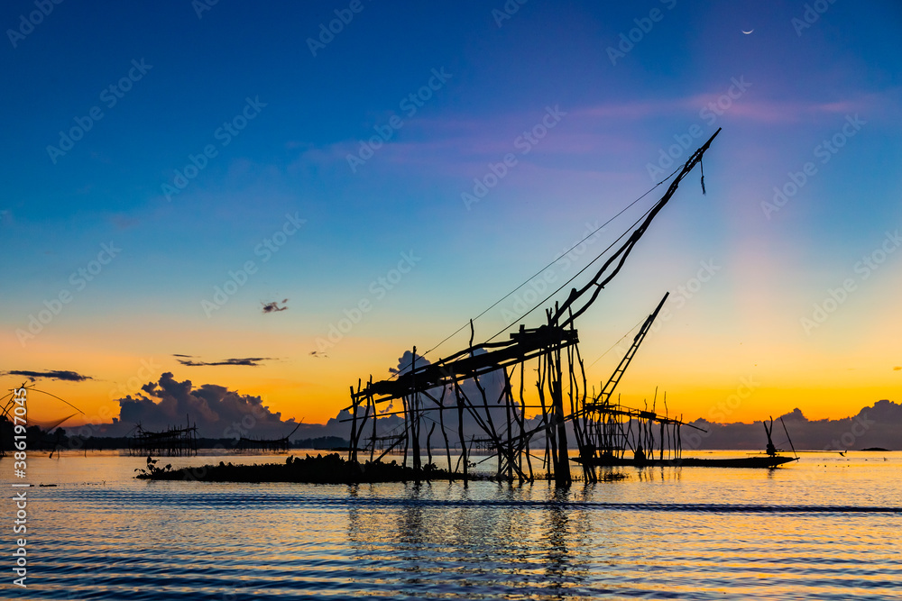 Chinese fish nets during sunrise in Phatthalung province, Thailand