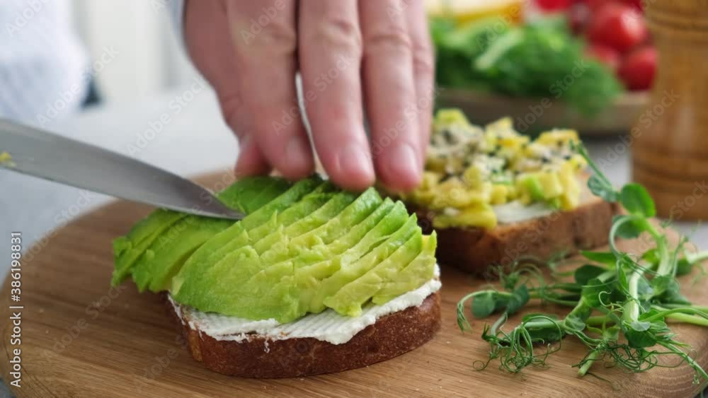 Toast with avocado and cream cheese. Healthy breakfast, lunch or snack. Cooking healthy food Toast with avocado and cream cheese. Healthy breakfast, lunch or snack. Cooking healthy food