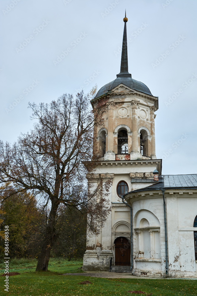 An old Russian little forgotten church against the background of a gloomy autumn sky. Landscape.