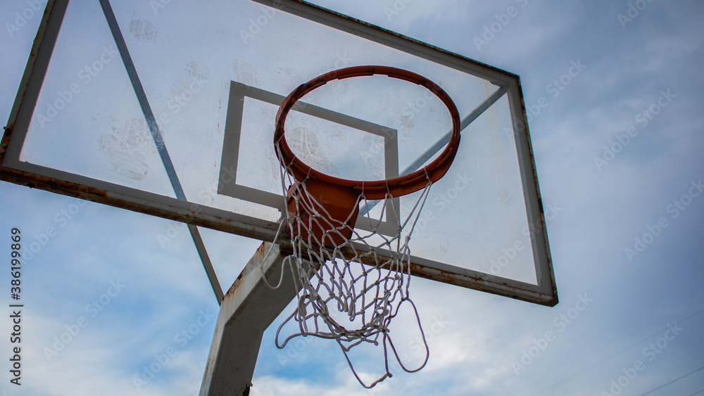 Naklejka premium Basketball hoop on the background of sky, blue sky and a basketball hoop, sports with basketball hoop