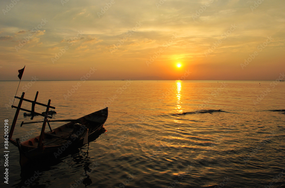 Fishing boat at sunset off the coast in Cambodia