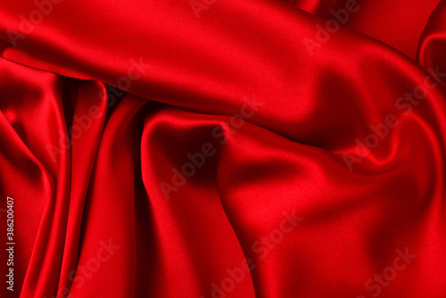 Red silk or satin luxury fabric texture can use as abstract background. Top view