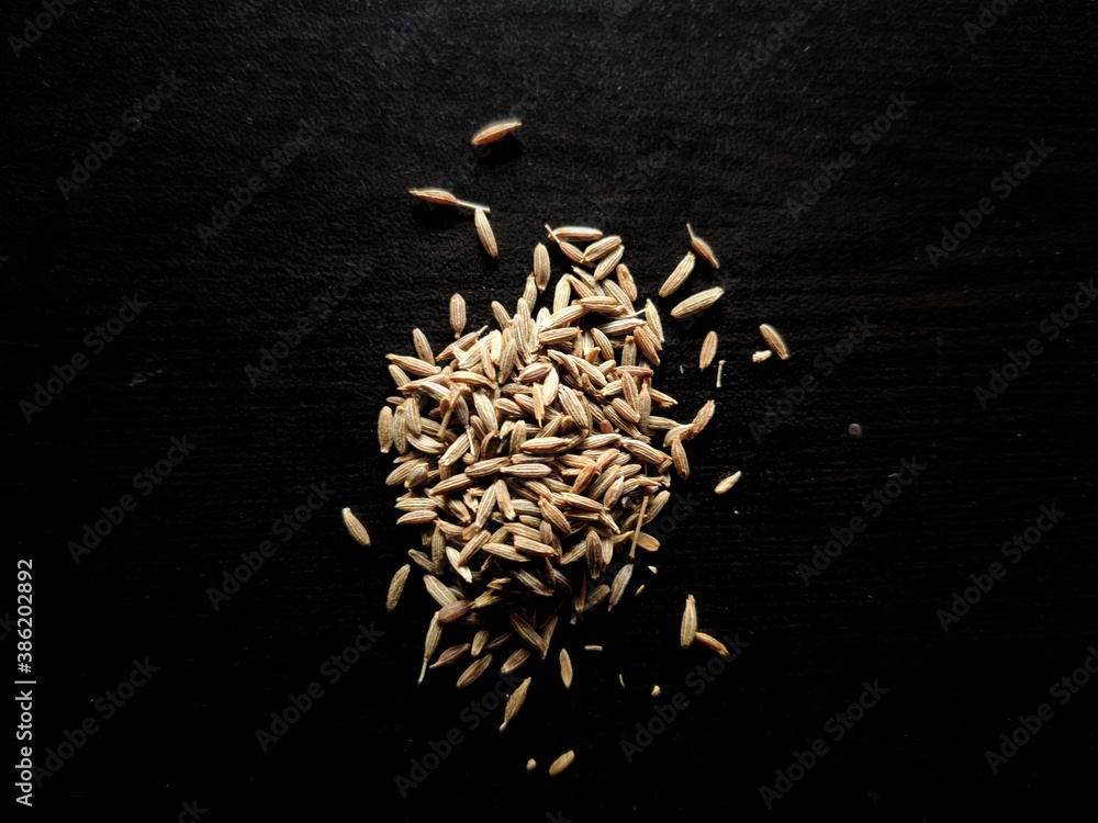 Indian spices called as Cumin kept in a black background. It is also