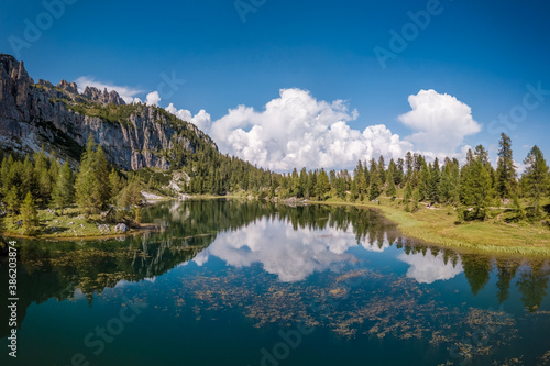Blue sky and white clouds reflections in lake Croda da Lago  in Cortina d Ampezzo in the Dolomites  Italy