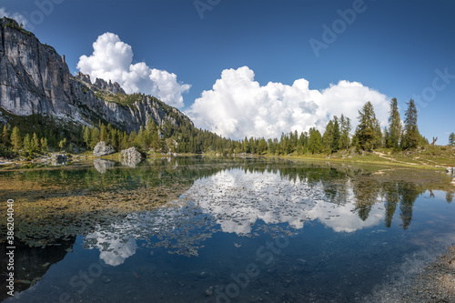 Fototapeta Naklejka Na Ścianę i Meble -  Blue sky and white clouds reflections in lake Croda da Lago, in Cortina d'Ampezzo in the Dolomites, Italy