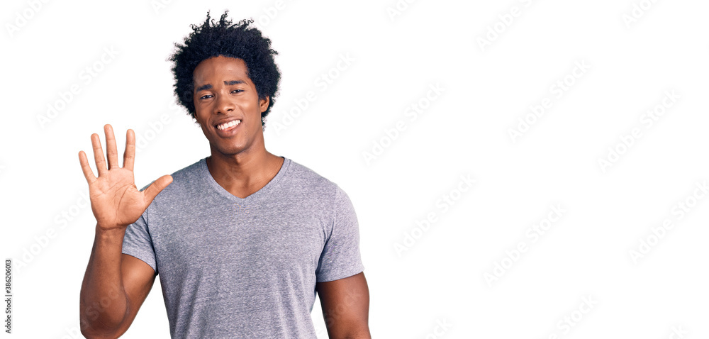 Handsome african american man with afro hair wearing casual clothes showing and pointing up with fingers number five while smiling confident and happy. Handsome african american man with afro hair wearing casual clothes showing and pointing up with fingers number five while smiling confident and happy.