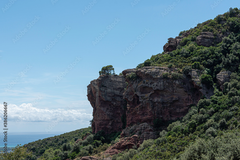 natural landscape of a rock mountain with blue sky in the background and white clouds natural landscape of a rock mountain with blue sky in the background and white clouds