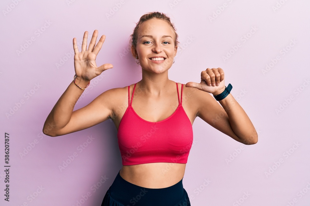 Beautiful caucasian woman wearing sportswear showing and pointing up with fingers number six while smiling confident and happy.