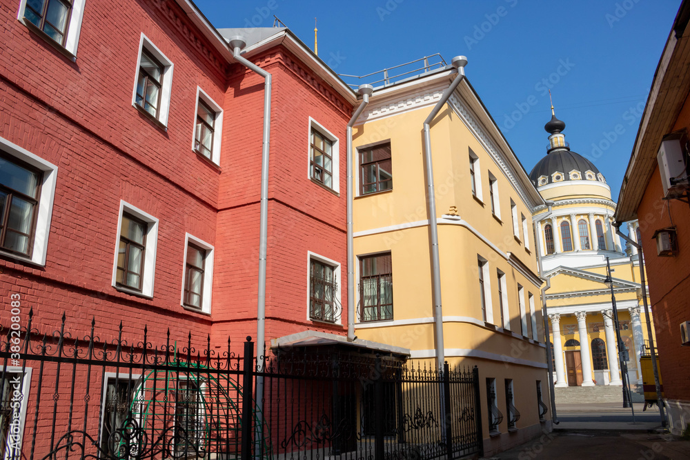 Fototapeta premium Exterior facade of the red house. Urban vintage background.Bright facades