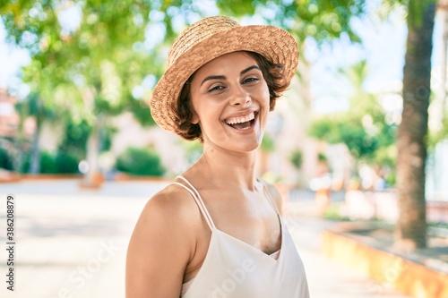 Young hispanic woman on vacation smiling happy walking at the park © Krakenimages.com