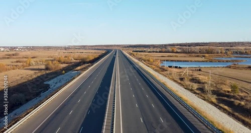 Narrow two - lane road,cars moving along the road-aerial photography