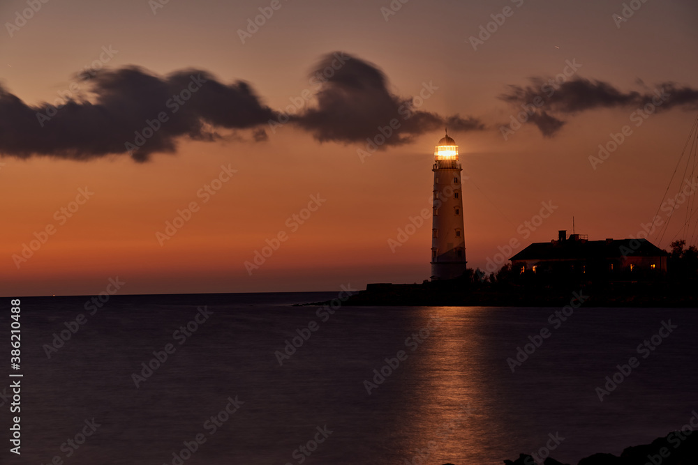 beautiful tall white lighthouse at sunset Crimea peninsula Cape Fiolent