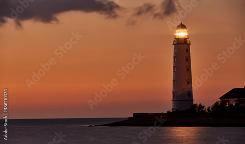 beautiful tall white lighthouse at sunset Crimea peninsula Cape Fiolent