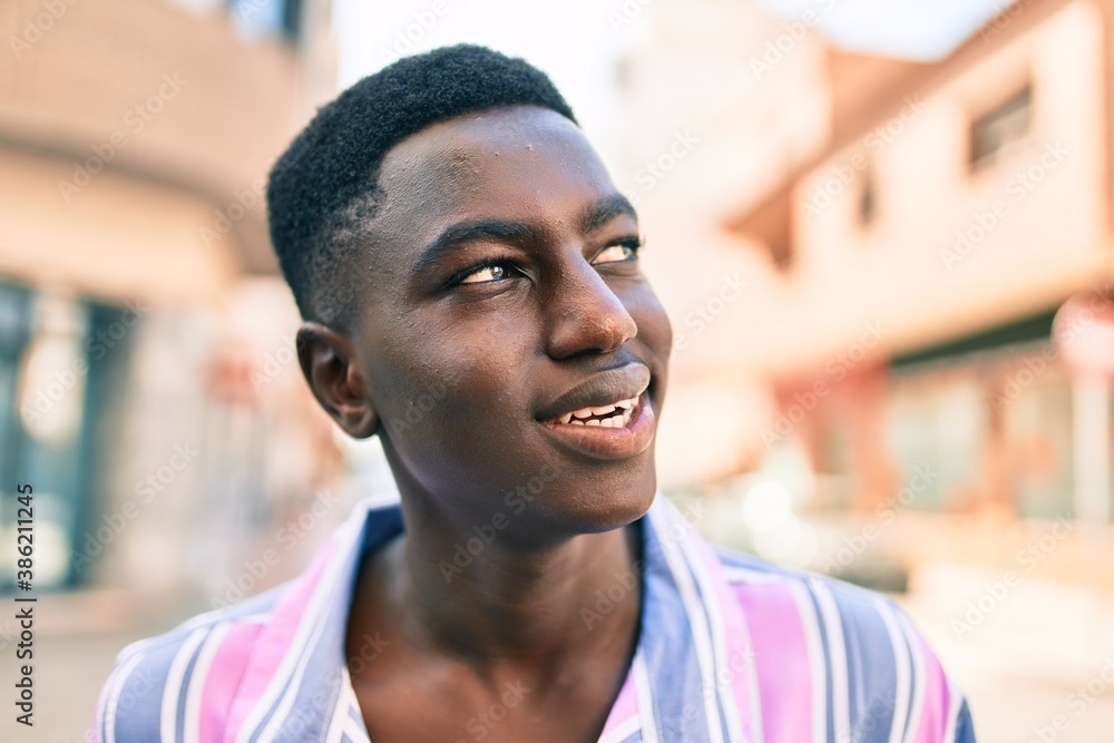 Young african american man smiling happy standing at street of city. Young african american man smiling happy standing at street of city.