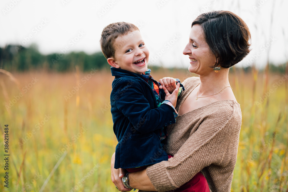 Portrait of mother holding young happy boy outdoors Portrait of mother holding young happy boy outdoors
