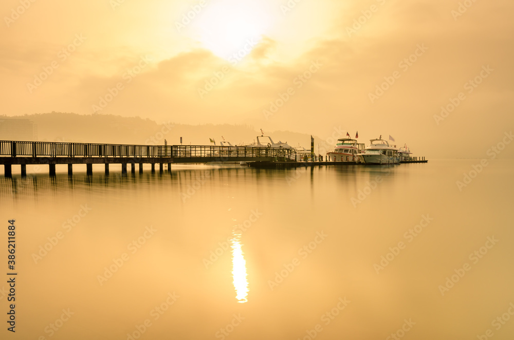 Beautiful sun rise scene of boats at pier at Sun Moon Lake, Taiwan.