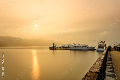 Beautiful sun rise scene of boats at pier at Sun Moon Lake, Taiwan. © THANAN