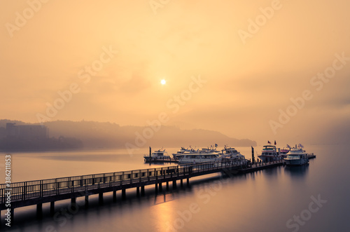 Beautiful sun rise scene of boats at pier at Sun Moon Lake, Taiwan. © THANAN