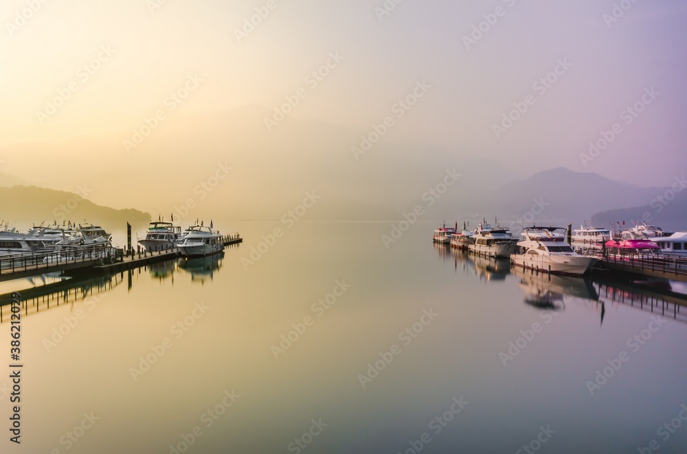 Beautiful sun rise scene of boats at pier at Sun Moon Lake, Taiw Beautiful sun rise scene of boats at pier at Sun Moon Lake, Taiw