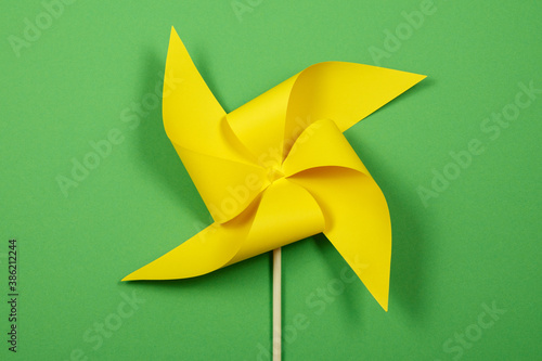 Yellow windmill on the green background.