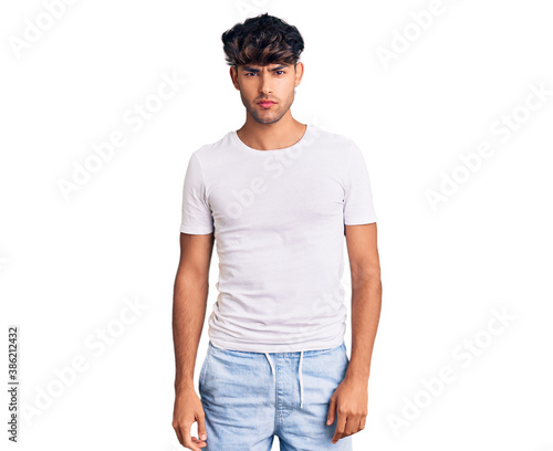 Young hispanic man wearing casual clothes skeptic and nervous, frowning upset because of problem. negative person.