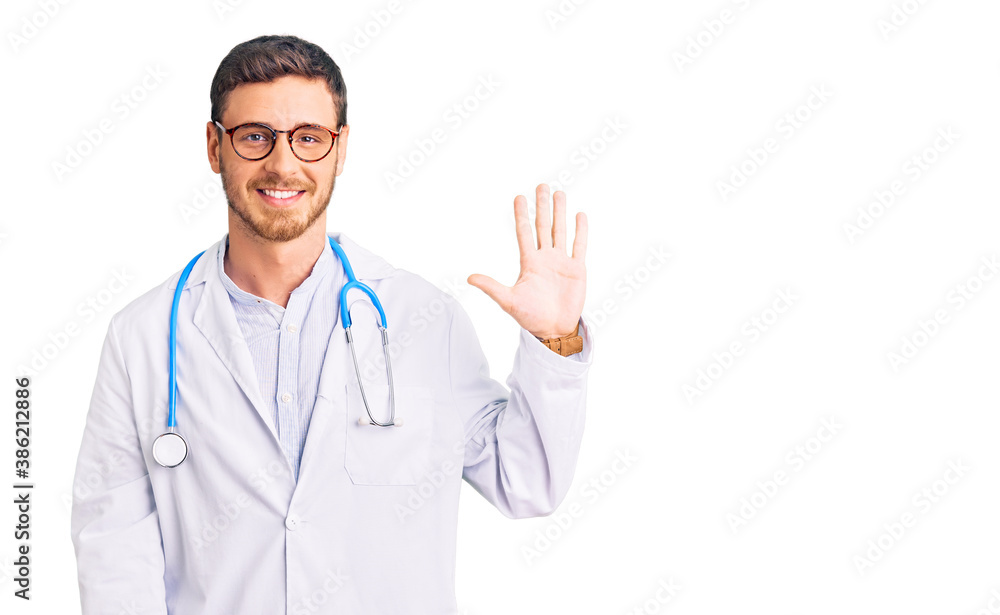 Handsome young man with bear wearing doctor uniform showing and pointing up with fingers number five while smiling confident and happy. Handsome young man with bear wearing doctor uniform showing and pointing up with fingers number five while smiling confident and happy.