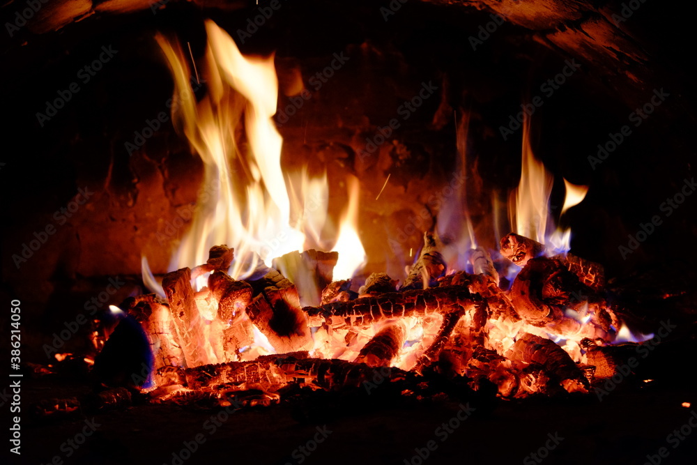 Logs burning in the oven. Flames and heat on the wood. Hot logs. Logs burning in the oven. Flames and heat on the wood. Hot logs.