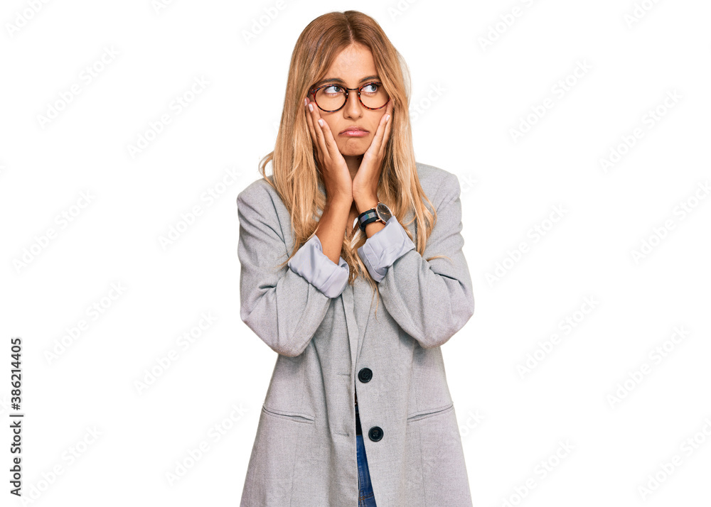 Beautiful blonde young woman wearing business clothes tired hands covering face, depression and sadness, upset and irritated for problem Beautiful blonde young woman wearing business clothes tired hands covering face, depression and sadness, upset and irritated for problem