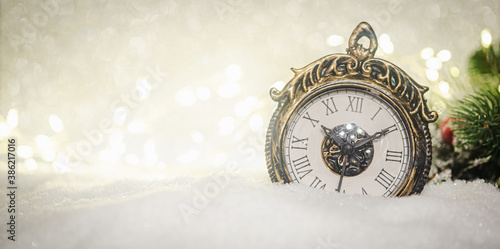 Christmas decoration with clock over snow lighting background.