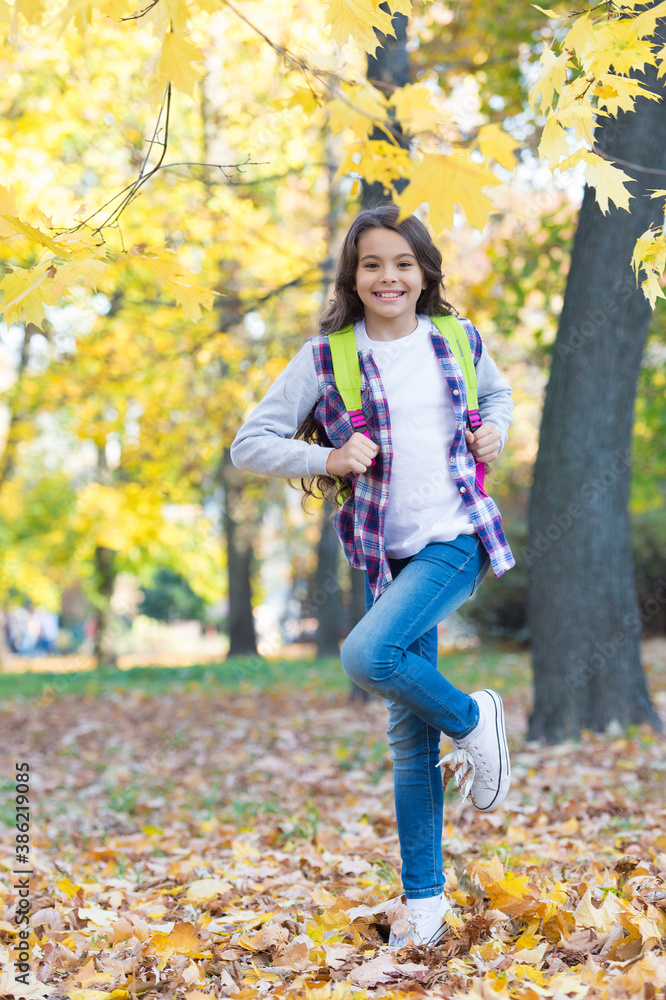 Back to school season. Happy child carry backpack in autumn park. Back to school. September 1. Knowledge day. Outdoor education and activites. Learn about fall Back to school season. Happy child carry backpack in autumn park. Back to school. September 1. Knowledge day. Outdoor education and activites. Learn about fall