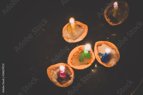 christmas traditional customs  - nut shell with burning candle floating on water
