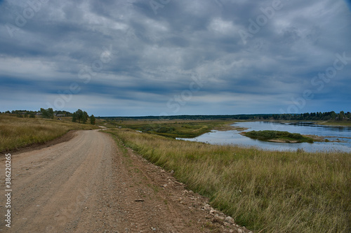 Forest dirt road in the wilderness along the river