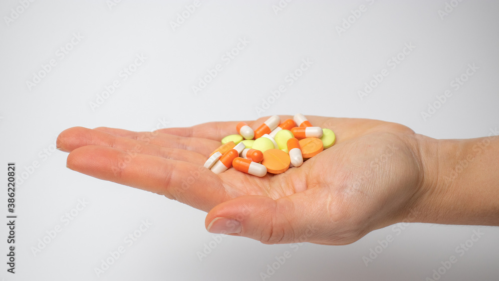 Colored painkillers capsules and tablets on the palm Colored painkillers capsules and tablets on the palm