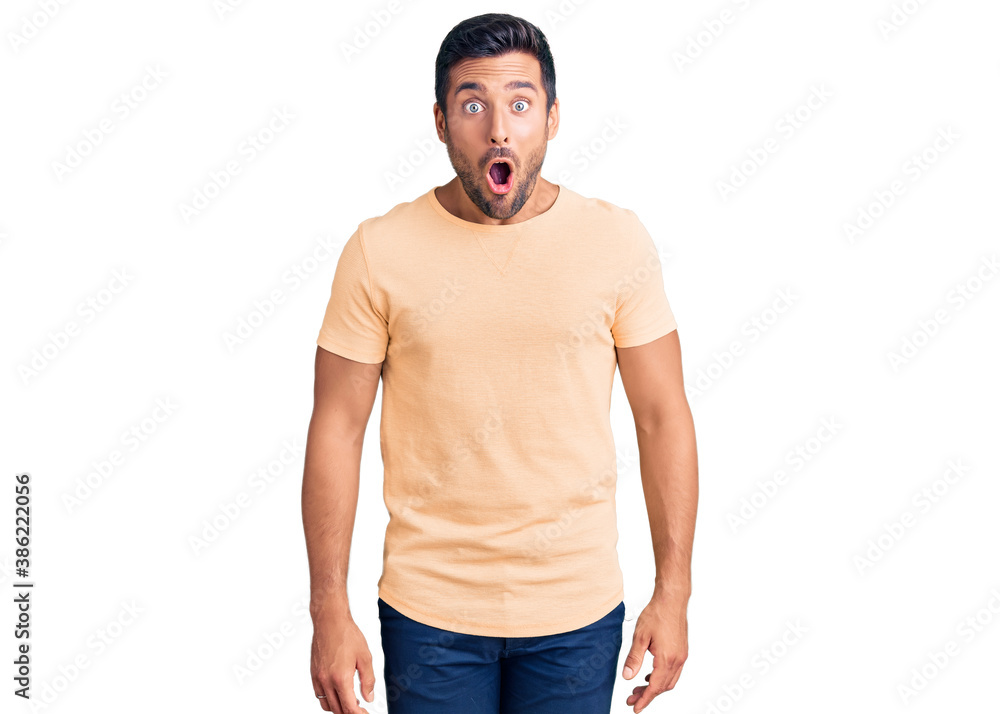 Fototapeta premium Young hispanic man wearing casual clothes afraid and shocked with surprise expression, fear and excited face.