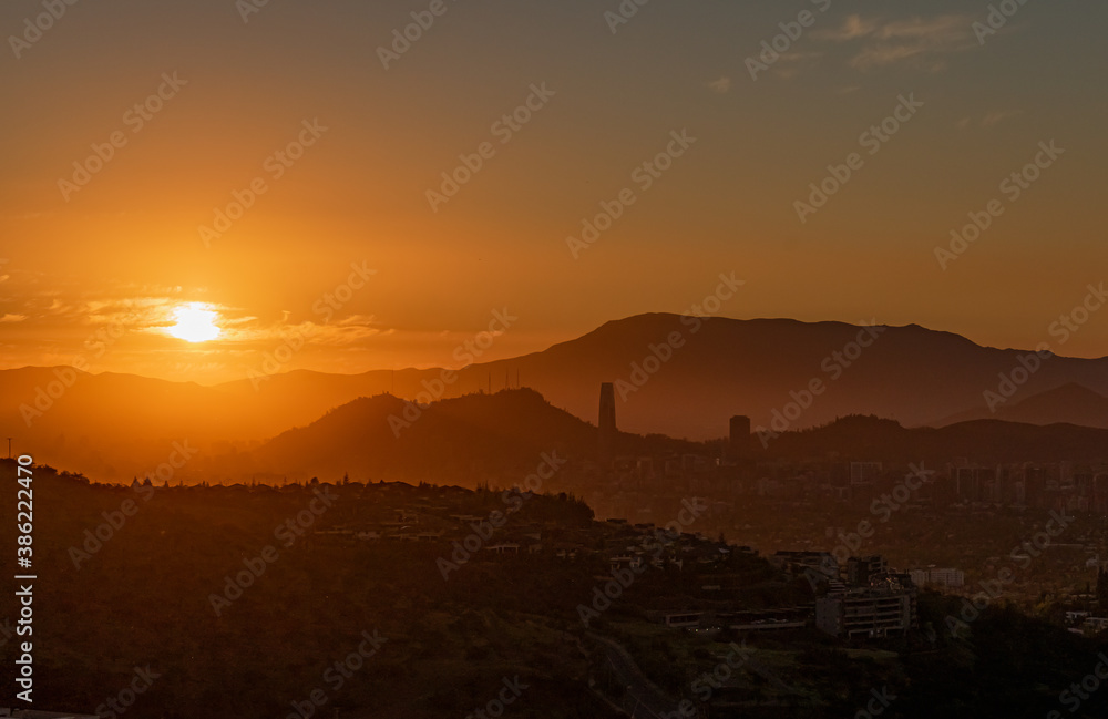 Aerial view of the sunset in the city Santiago with the hills at the back.  
