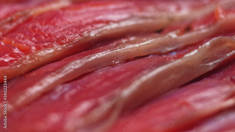 Close up shot of smoothly rotating salmon, Sushi cooking process - Philadelphia, burning fire smoking fresh raw red tuna salmon eel. Makro Close up shot of smoothly rotating salmon, Sushi cooking process - Philadelphia, burning fire smoking fresh raw red tuna salmon eel. Makro