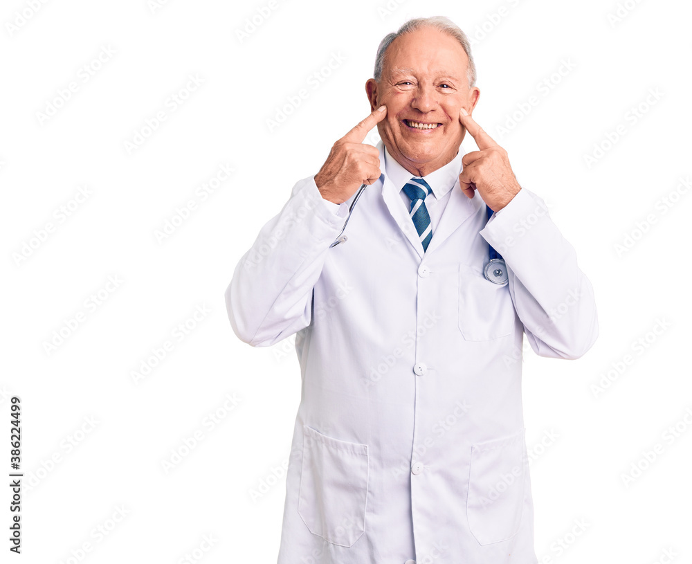 Senior handsome grey-haired man wearing doctor coat and stethoscope smiling with open mouth, fingers pointing and forcing cheerful smile Senior handsome grey-haired man wearing doctor coat and stethoscope smiling with open mouth, fingers pointing and forcing cheerful smile