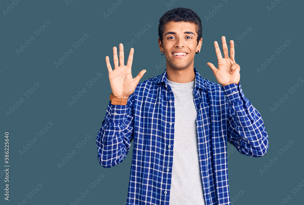 Young african amercian man wearing casual clothes showing and pointing up with fingers number nine while smiling confident and happy. Young african amercian man wearing casual clothes showing and pointing up with fingers number nine while smiling confident and happy.