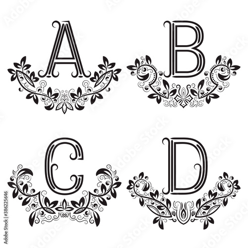 A, B, C, D vintage monograms in floral wreaths. Set of black letters in laurels.