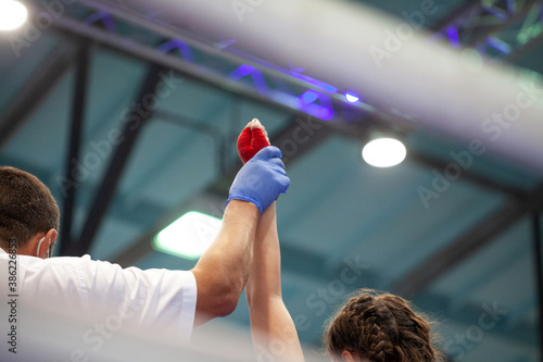 Boxing judge raised girl hand up when announcing a winner in a competition