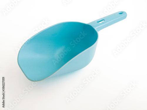 Photography Blue plastic pet food shovel isolated on white background