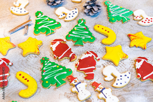 colorful Christmas homemade gingerbread cookies with snow background