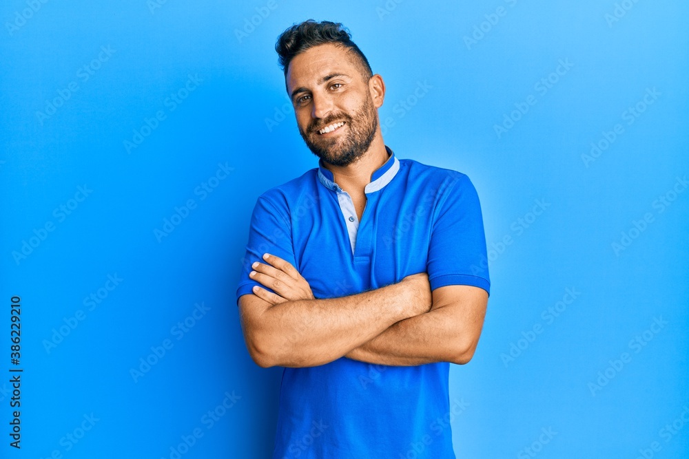 Handsome man with beard wearing casual clothes happy face smiling with crossed arms looking at the camera. positive person. Handsome man with beard wearing casual clothes happy face smiling with crossed arms looking at the camera. positive person.