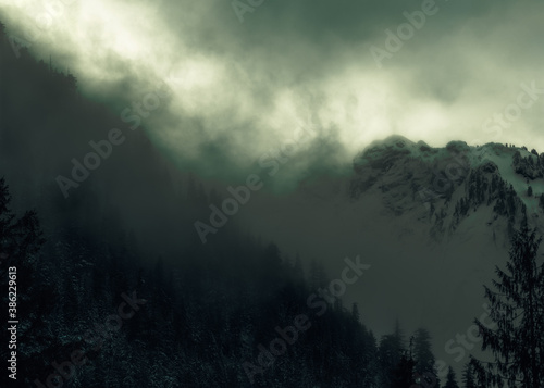 Dramatic dark, mysterious, and moody mountains in the foggy Pacific Northwest