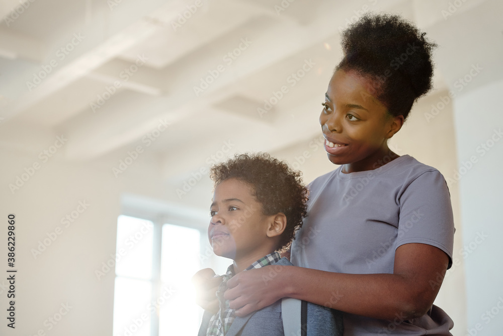 © pressmaster - Happy young careful mother buttoning up shirt of her adorable little son © pressmaster - Happy young careful mother buttoning up shirt of her adorable little son