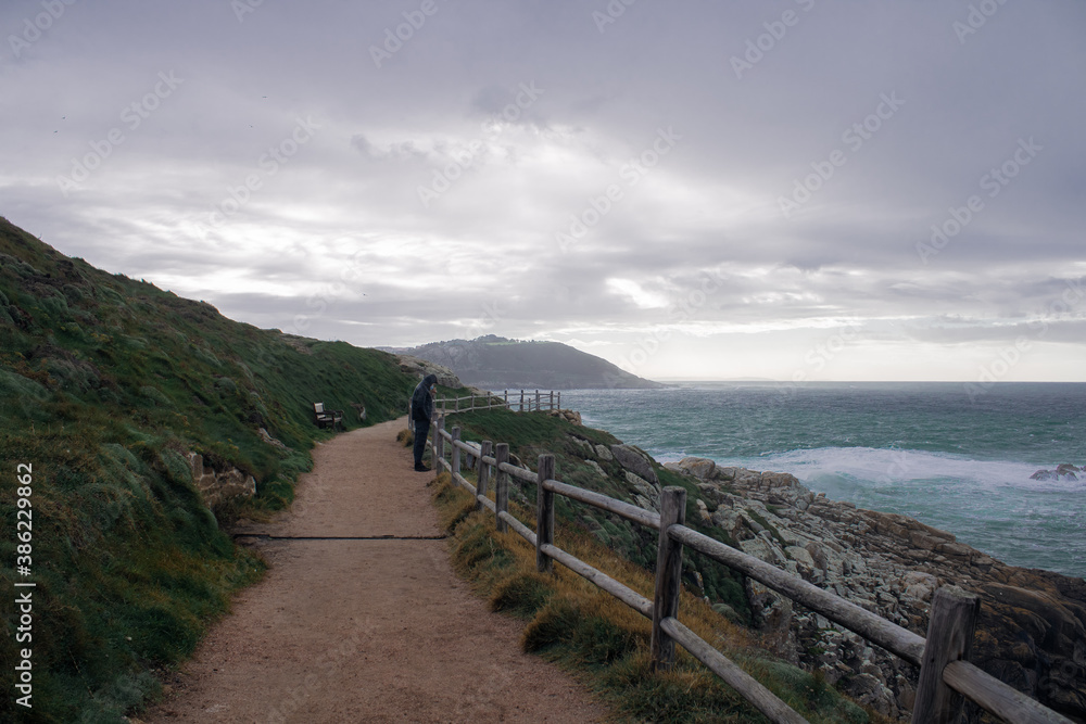A Coruña, coast of Spain during a rain with a man looking to the sea